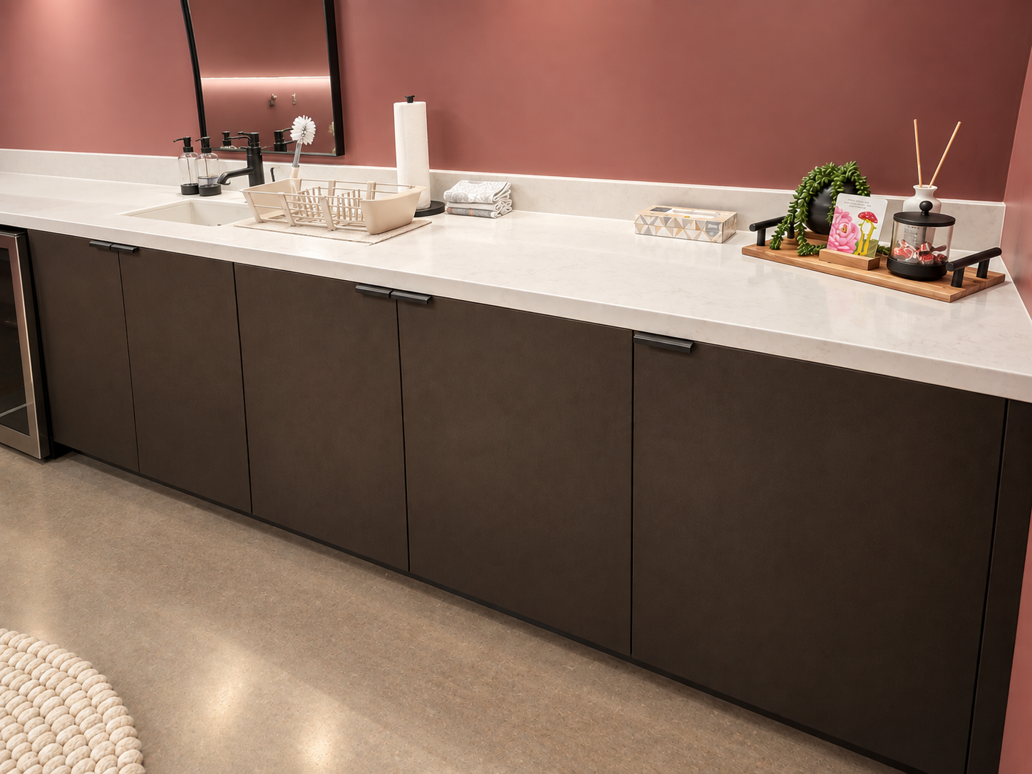Angled view of small room with a white countertop and dark brown Ekoa flax surface covering cabinets below it