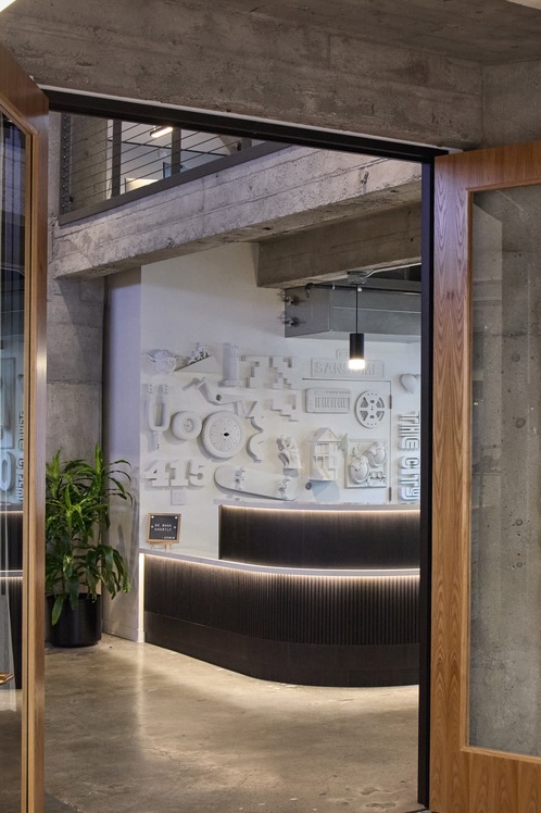 Reception desk featuring Ekoa flax surface, seen through doorway
